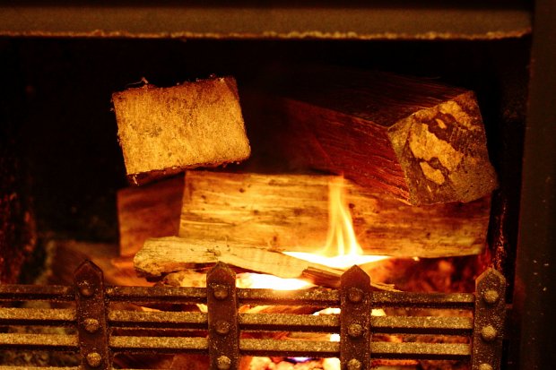 Next add some small logs in a way that ensures they do not collapse the pile of kindling, smothering your fire